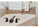 Close up of a clean, bright bathtub with bronze fixtures and tile accents at 50 Consella Way, Franklinton, NC 27525