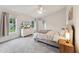 Comfortable bedroom featuring soft carpet, a ceiling fan, and lots of natural light at 50 Consella Way, Franklinton, NC 27525