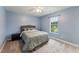 This bedroom has blue walls, a ceiling fan and a window with a beautiful view at 50 Consella Way, Franklinton, NC 27525