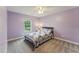 Bedroom featuring lilac-painted walls, a ceiling fan, and natural light at 50 Consella Way, Franklinton, NC 27525