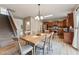 Open dining area featuring a wood table, chandelier, and staircase in the background at 50 Consella Way, Franklinton, NC 27525