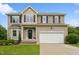 Inviting two-story home with a well-kept lawn, flower beds, and a spacious two-car garage at 50 Consella Way, Franklinton, NC 27525