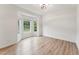 Well-lit living room with wood floors and a bay window offering views of the outdoors at 50 Consella Way, Franklinton, NC 27525