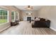 Bright living room with fireplace, wood-look floors, and large windows overlooking the backyard at 50 Consella Way, Franklinton, NC 27525