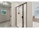 Bathroom with a walk-in shower and view into adjoining room at 50 Consella Way, Franklinton, NC 27525
