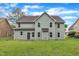 A beautifully kept backyard with plush lawn, backing up to a large two-story home at 5025 Stonewood Pines Dr, Knightdale, NC 27545