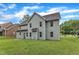 Backyard view of a two-story home, siding, a well-manicured lawn and vibrant green trees at 5025 Stonewood Pines Dr, Knightdale, NC 27545