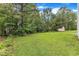 Large backyard showcases mature trees, a storage shed, and a well-manicured lawn at 5025 Stonewood Pines Dr, Knightdale, NC 27545