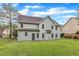 Expansive backyard with lush lawn, large two-story house, and mature trees at 5025 Stonewood Pines Dr, Knightdale, NC 27545