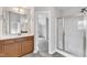 This bathroom offers a single vanity, a glass door shower and a view into the closet at 5025 Stonewood Pines Dr, Knightdale, NC 27545