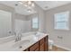 Bright bathroom features a double vanity, a large mirror and a window for natural light at 5025 Stonewood Pines Dr, Knightdale, NC 27545
