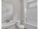 Bathroom features a pedestal sink, toilet, and shower-tub combo with a small window at 5025 Stonewood Pines Dr, Knightdale, NC 27545