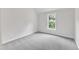 This bedroom features a plush carpet, a double pane window, and ample natural light at 5025 Stonewood Pines Dr, Knightdale, NC 27545