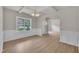 Dining room featuring decorative trim, light wood floors, and a view of the front yard at 5025 Stonewood Pines Dr, Knightdale, NC 27545