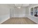 Dining room featuring decorative trim, light wood floors, and a large window at 5025 Stonewood Pines Dr, Knightdale, NC 27545