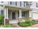 Welcoming front porch with stone accents and a dark-colored front door at 5025 Stonewood Pines Dr, Knightdale, NC 27545