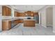 Stylish kitchen boasts stainless steel appliances, wood cabinets, an island, and plenty of counter space at 5025 Stonewood Pines Dr, Knightdale, NC 27545