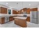 Beautiful kitchen with a central island, stainless steel appliances, wood cabinets, and granite countertops at 5025 Stonewood Pines Dr, Knightdale, NC 27545