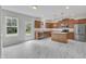 Kitchen features an island and stainless steel appliances and access to the yard at 5025 Stonewood Pines Dr, Knightdale, NC 27545