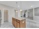 Charming kitchen with wood cabinets, granite countertops, stainless steel appliances, and luxury vinyl flooring at 5025 Stonewood Pines Dr, Knightdale, NC 27545