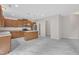 Modern kitchen featuring wood cabinets, stainless steel appliances, an island, and luxury vinyl flooring at 5025 Stonewood Pines Dr, Knightdale, NC 27545