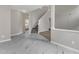 Spacious living area featuring luxury vinyl flooring, staircase and an open layout to other rooms at 5025 Stonewood Pines Dr, Knightdale, NC 27545