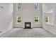 Bright living room with a fireplace and large windows at 5025 Stonewood Pines Dr, Knightdale, NC 27545