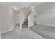 Open-concept living room features modern flooring, a staircase, and abundant natural light at 5025 Stonewood Pines Dr, Knightdale, NC 27545