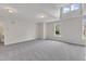 Spacious living room with soft carpeting and multiple windows providing natural light at 5025 Stonewood Pines Dr, Knightdale, NC 27545