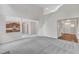 Spacious living room with gray carpet flooring and a view to the kitchen and entry at 5025 Stonewood Pines Dr, Knightdale, NC 27545