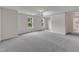 Expansive living area with new carpeting, natural light, and neutral paint tones at 5025 Stonewood Pines Dr, Knightdale, NC 27545