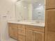 This bathroom features a wood vanity with double sinks and quartz countertop, as well as a large mirror at 5029 Jowetts Walk Dr # 29, Cary, NC 27519