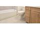 Bathroom showcasing a tub, toilet, and vanity with wood cabinets, offering ample storage at 5029 Jowetts Walk Dr # 29, Cary, NC 27519