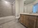 Bathroom featuring a bathtub, toilet, and a wooden vanity with light countertop at 5029 Jowetts Walk Dr # 29, Cary, NC 27519