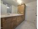 Bathroom with double sink vanity with granite top, wood cabinets, and decorative tile flooring at 5029 Jowetts Walk Dr # 29, Cary, NC 27519
