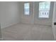 Bedroom featuring plush carpeting and two bright windows, creating a comfortable space at 5029 Jowetts Walk Dr # 29, Cary, NC 27519