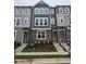 New construction townhome featuring a stone facade, blue accents and crisp white-framed windows at 5029 Jowetts Walk Dr # 29, Cary, NC 27519