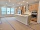 Spacious kitchen featuring a large island, stainless steel appliances, and ample counter space at 5029 Jowetts Walk Dr # 29, Cary, NC 27519