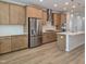 Kitchen features stainless steel appliances, light wood cabinets, and white backsplash at 5029 Jowetts Walk Dr # 29, Cary, NC 27519
