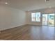Inviting living room featuring wood flooring and sliding glass doors leading to outdoor space at 5029 Jowetts Walk Dr # 29, Cary, NC 27519
