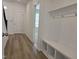 Mudroom with built-in bench and storage, coat hooks, and wood-look flooring at 5029 Jowetts Walk Dr # 29, Cary, NC 27519