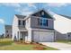 Traditional two-story home featuring gray siding, a two-car garage, and a green lawn at 51 Crow Field St, Roxboro, NC 27574