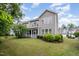 Backyard view featuring a well-maintained lawn, established landscaping, and a screened porch for outdoor living at 522 Finnbar Dr, Cary, NC 27519