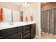 Double vanity bathroom featuring dark cabinets, mirror, and a separate toilet at 522 Finnbar Dr, Cary, NC 27519