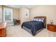 Bedroom featuring two windows, desk, and a stylish bed with blue covers at 522 Finnbar Dr, Cary, NC 27519