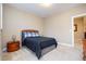 Bedroom featuring stylish bed, side table with lamp, and natural light at 522 Finnbar Dr, Cary, NC 27519