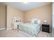 Neutral bedroom featuring a vanity, bedside table, and bright natural light at 522 Finnbar Dr, Cary, NC 27519
