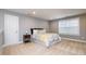 Grey bedroom featuring a window, modern door, and stylish bed at 522 Finnbar Dr, Cary, NC 27519