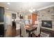 Elegant dining room with a stacked stone fireplace and modern chandelier lighting at 522 Finnbar Dr, Cary, NC 27519