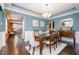Elegant dining room with wainscoting, chandelier, and a view into the living room, ideal for formal gatherings at 522 Finnbar Dr, Cary, NC 27519